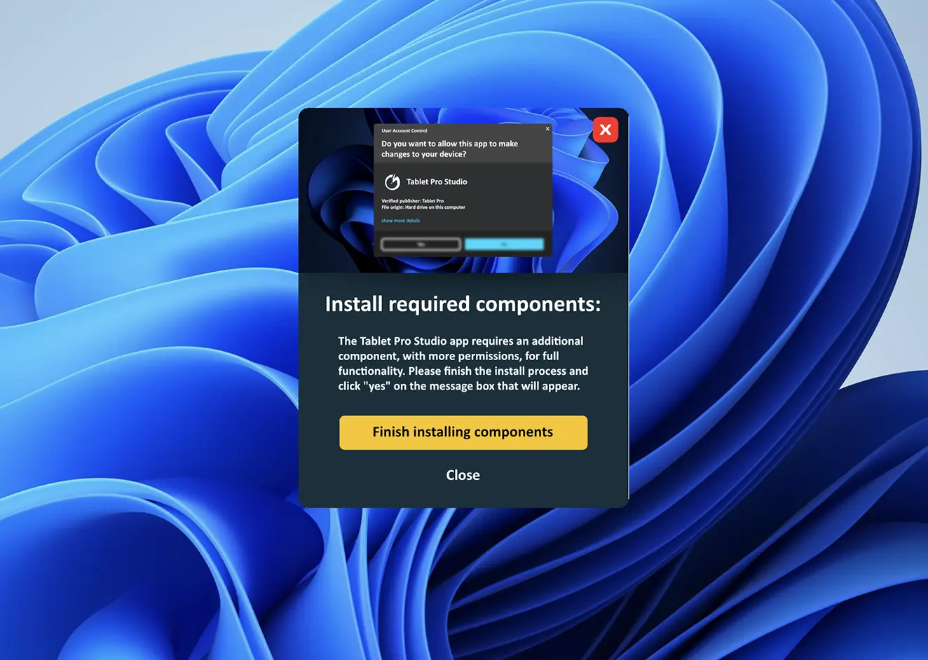 Popup window prompting to install required components for Tablet Pro Studio on a dark panel with a yellow 'Finish installing components' button and a 'Close' option over a blue abstract background