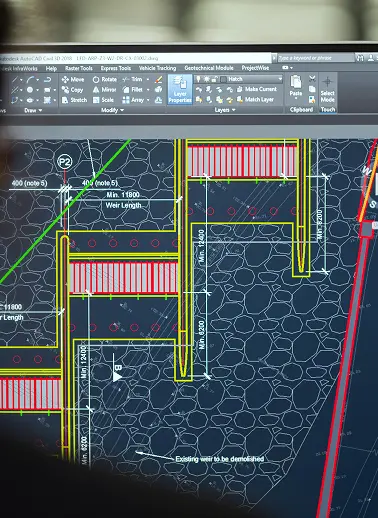 AutoCAD screen showing a site layout with yellow structural outlines, red hatching, and notes like 'Existing wall to be demolished' on a dark stone-textured background.